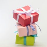 A stack of colorful gift boxes tied with ribbons, perfect for celebrations and festive occasions.
